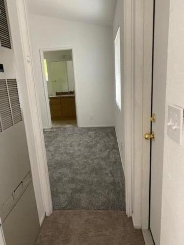 An empty room with a door and carpet.