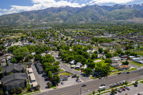 An aerial view of a town with mountains in the background.